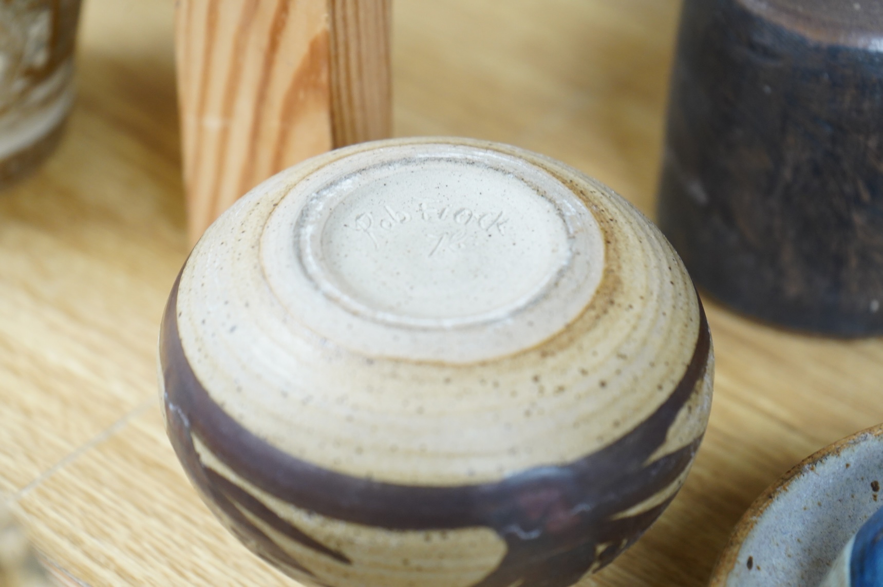A collection of studio pottery to include a small Danish squat vase, a Brannam, Devon vase and three small Dickerware pieces, largest 13cm high